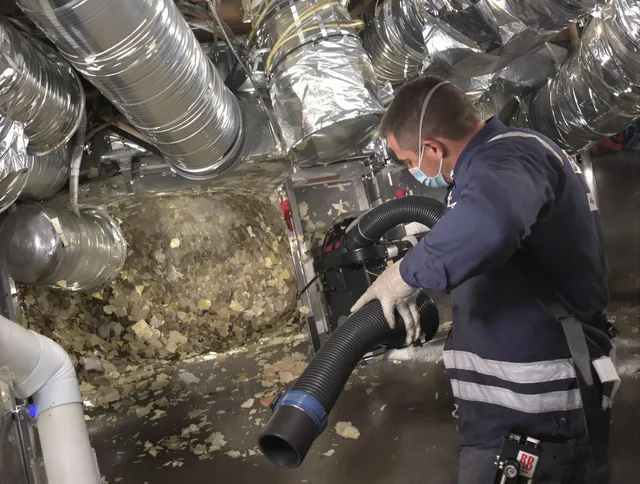 Southborough Air Duct Cleaning specialist operating negative pressure cleaning equipment for thorough duct maintenance in Southborough